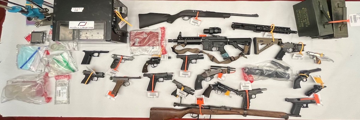 Convicted felon arrested with cache of firearms and explosive device