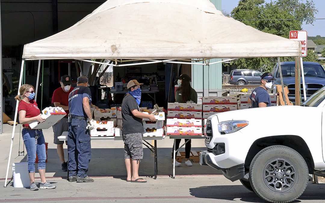 San Miguel Firefighters Association Assists with Fruit Box Giveaway