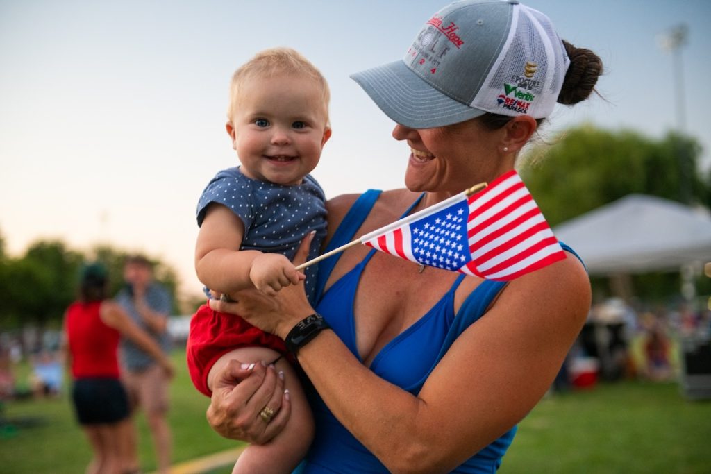 Mom and Baby holding American Flag at Paso Robles July 4th Celebration